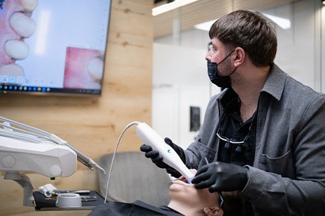 Dentist making digital impressions of patient’s teeth