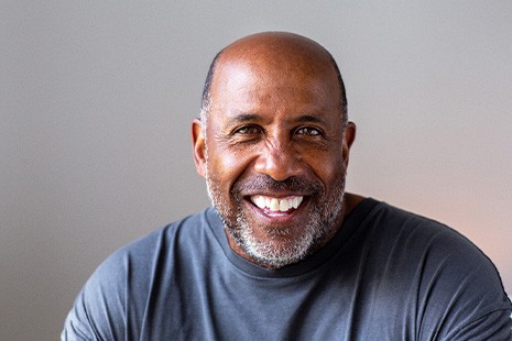 Closeup of senior man in gray shirt smiling