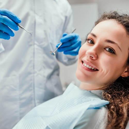 patient smiling while visiting dentist