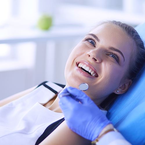 patient smiling while visiting dentist
