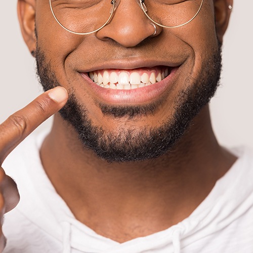 patient pointing to smile