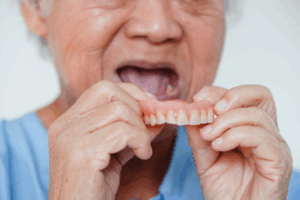 Man inserting dentures