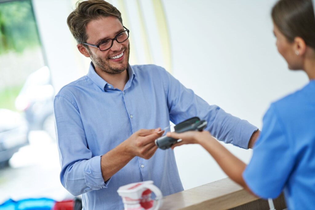 A man paying for dental treatment