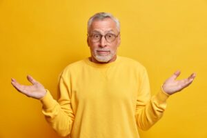 Man raising his hands in a confused manner